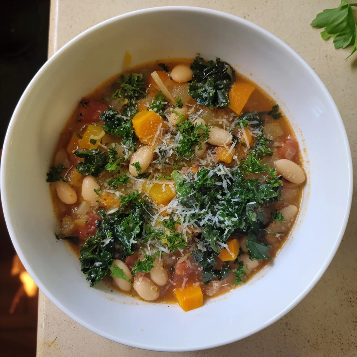 Close-up of a rustic Italian Bean & Kale Stew, flavorful with herbs and served with crusty bread.