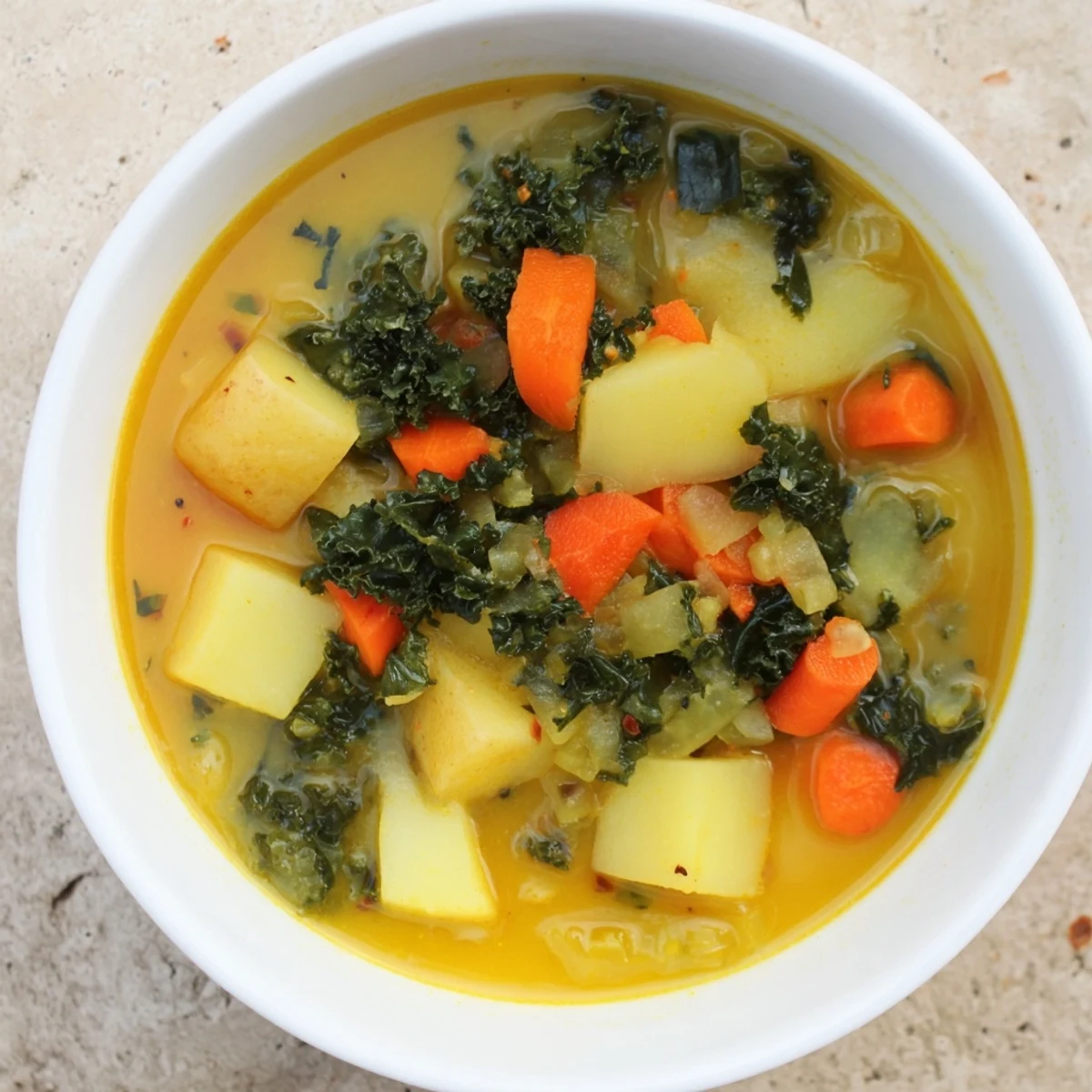 Steaming Vegetarian Potato-Kale Soup, a vibrant and flavorful bowl piled high with fresh greens.