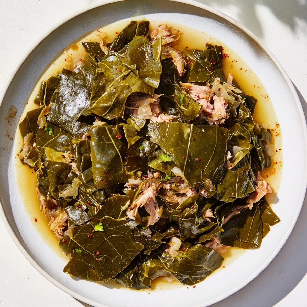 Close-up of vibrant Southern style collard greens with a smoky aroma, ready to enjoy alongside cornbread.