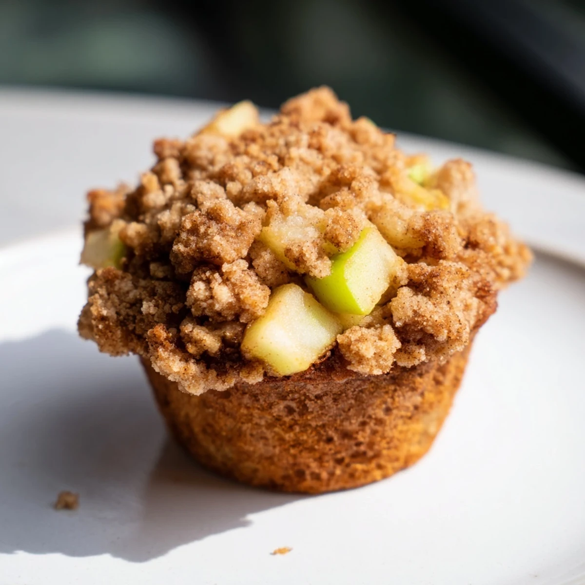 Golden-brown, delicious apple muffins with a sweet, buttery crumb topping, perfect for breakfast.