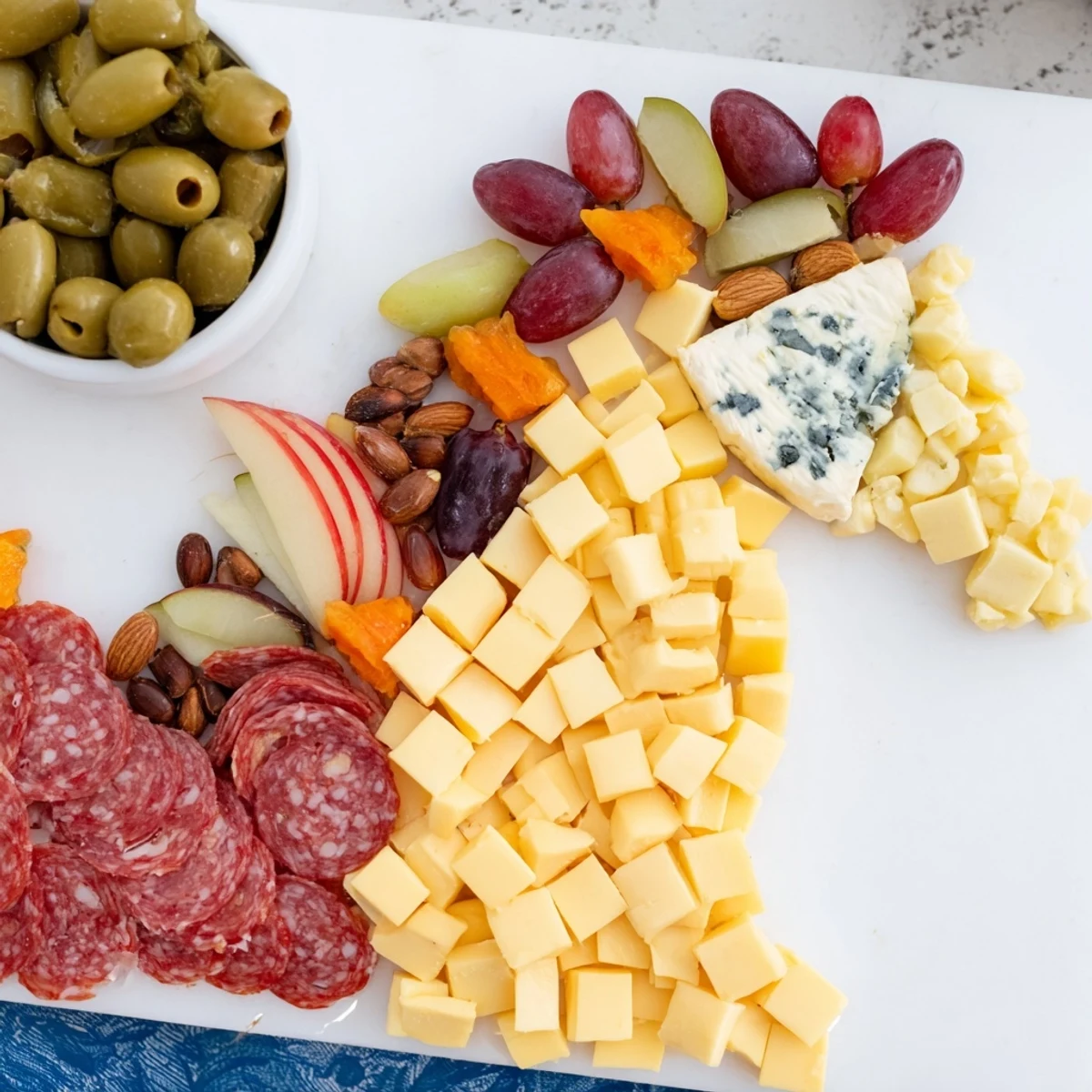 This horse-shaped grazing board beautifully displays assorted cheeses, charcuterie, and crackers, ideal for any gathering.