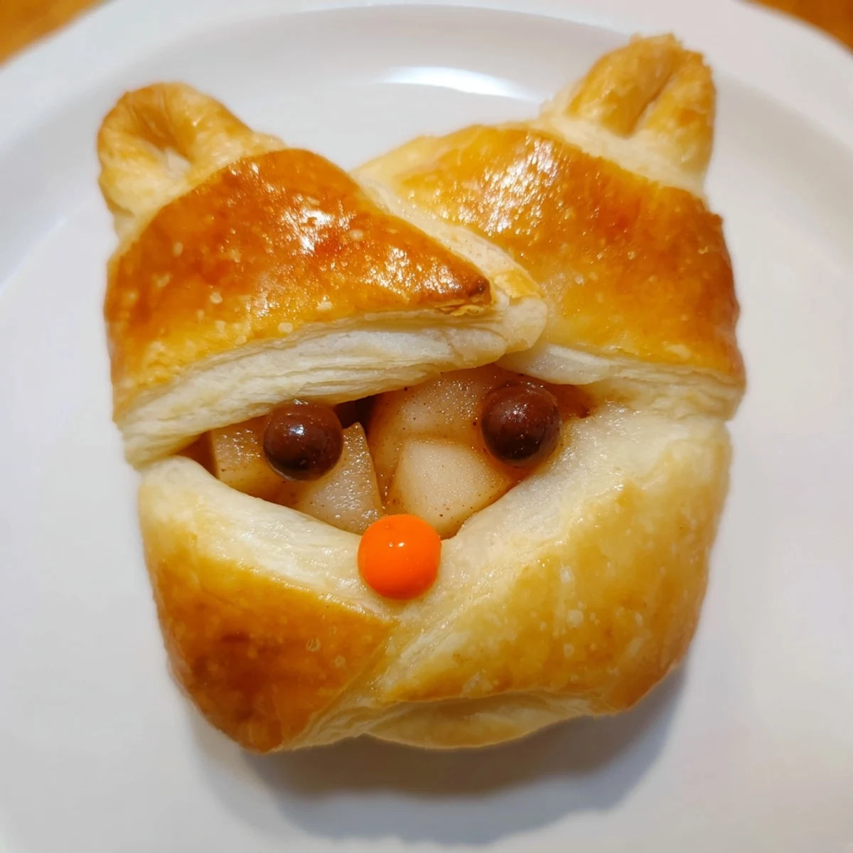 Golden-brown Autumn Harvest Fox-Shaped Bites, with glistening pastry, filled with spiced apple and pear.