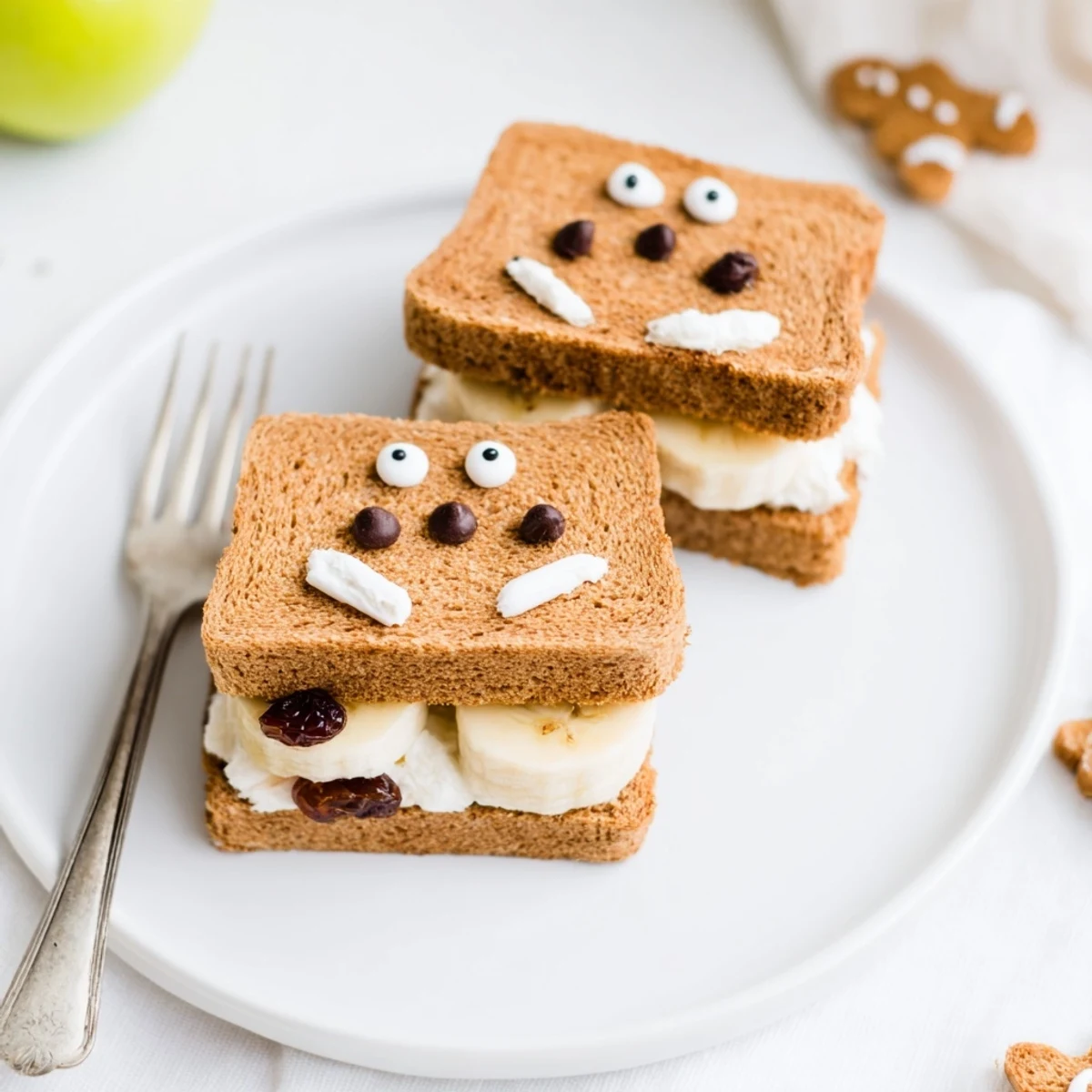 Gingerbread Man Sandwich Cutouts with raisin eyes and banana smiles, a delightful snack for kids.