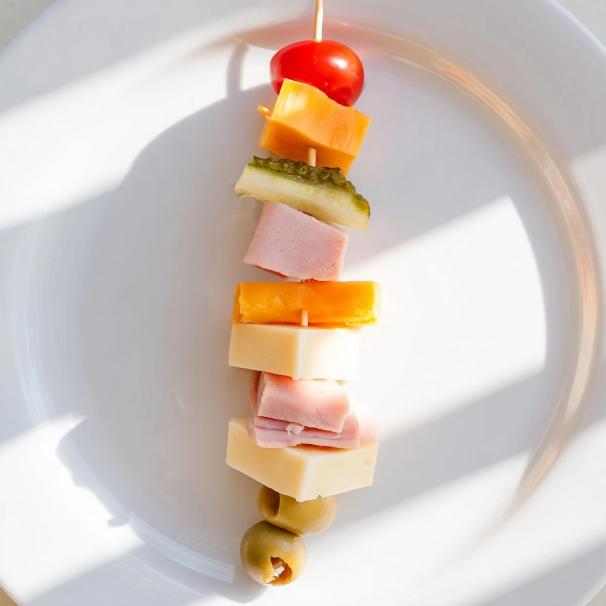 Delicious Savory Skewers, each with a tempting medley of ham, cheddar, and tangy dill pickle.