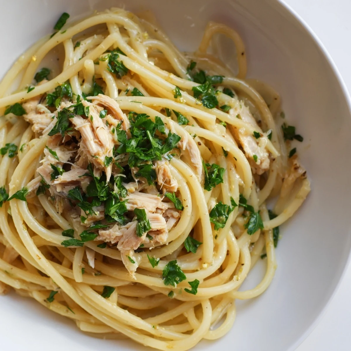 Golden strands of Simple Garlic Butter Bucatini pasta swirled with creamy garlic butter and juicy chicken.