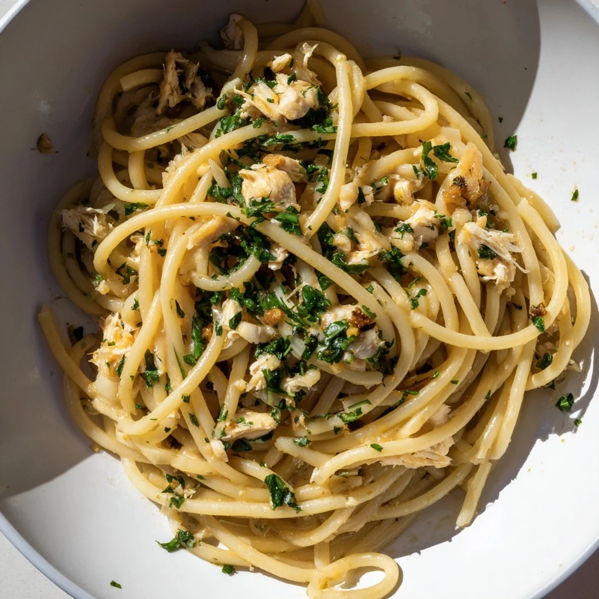 A close-up of steaming Simple Garlic Butter Bucatini, highlighting tender chicken and garlic's rich aroma.