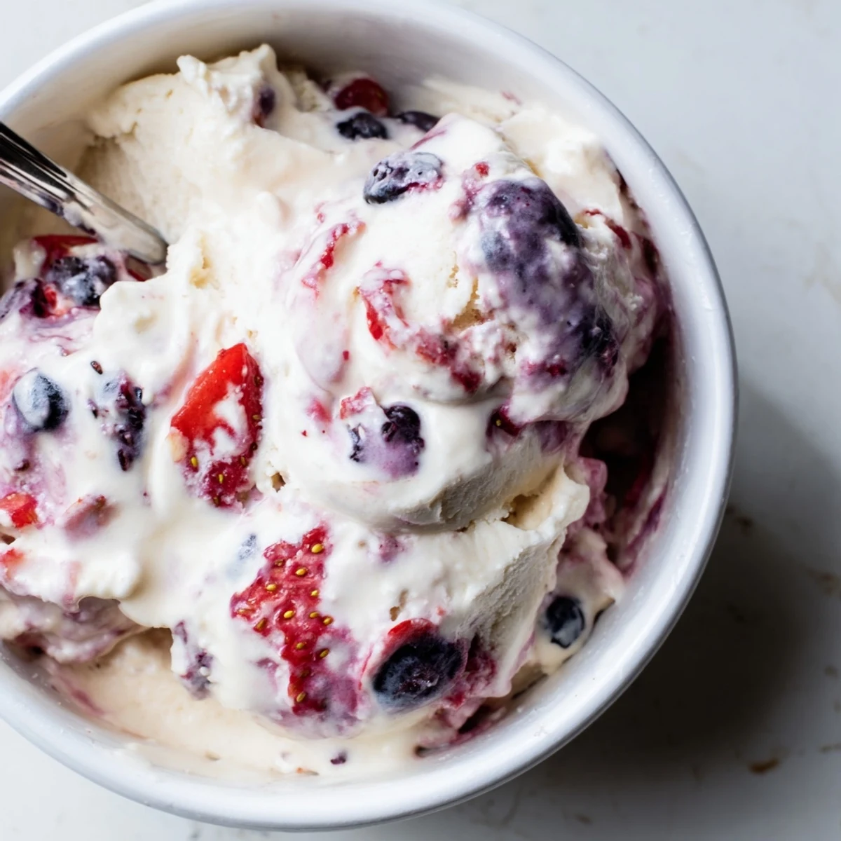 Creamy cottage cheese ice cream swirled with vibrant berries, a refreshing and easy homemade dessert.