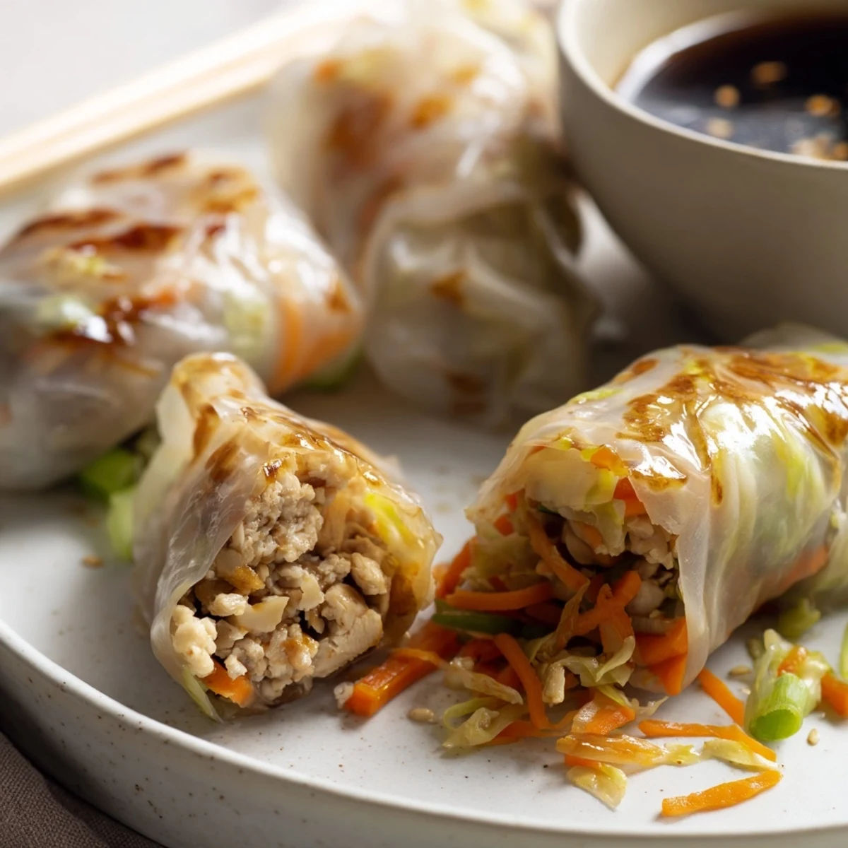 Close-up on a bite-sized Crispy Rice Paper Dumpling, showing the steam rising from the tender, savory filling inside.