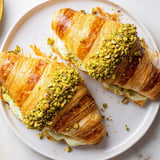 A close-up of buttery Pistachio Cream Croissants, showing a pistachio cream filling, ready to enjoy.