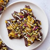 Homemade Pistachio Dubai Chocolate Bark featuring a drizzle of white chocolate and vibrant toppings on a tray.