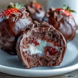 Rich dark chocolate-dipped strawberry truffles with pistachios and rose petals, inspired by Dubai's luxurious dessert traditions.