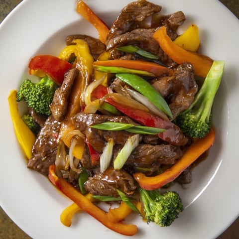 Tender beef and vegetable stir-fry served over fluffy rice, perfect for weeknight dinners.  