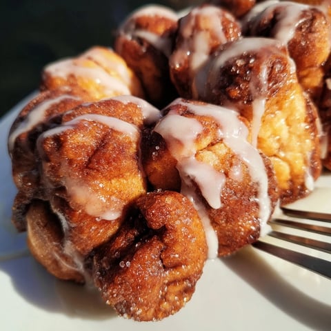Warm Cinnamon Sugar Monkey Bread baked to golden perfection, drizzled with sweet buttery glaze.  