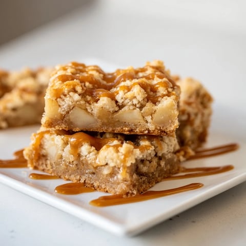 Gooey caramel apple cookie bars, with a golden top and warm, cinnamon-spiced apple filling.