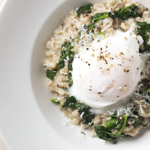 Savoury Oatmeal with Spinach & Poached Egg, a warm breakfast bowl with vibrant green spinach and golden egg.