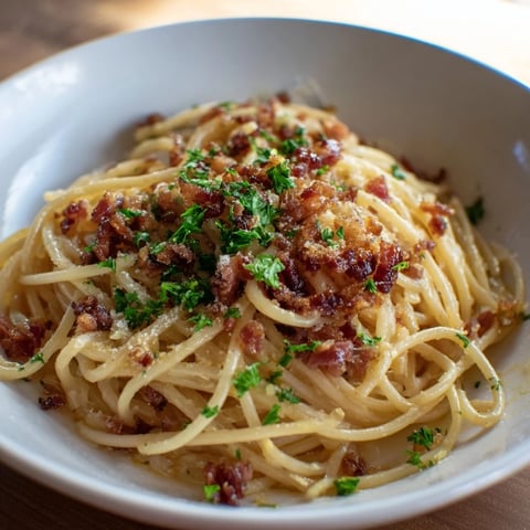 Golden Garlic Butter Pasta with Crispy Bacon, offering a symphony of textures and Italian flavors.