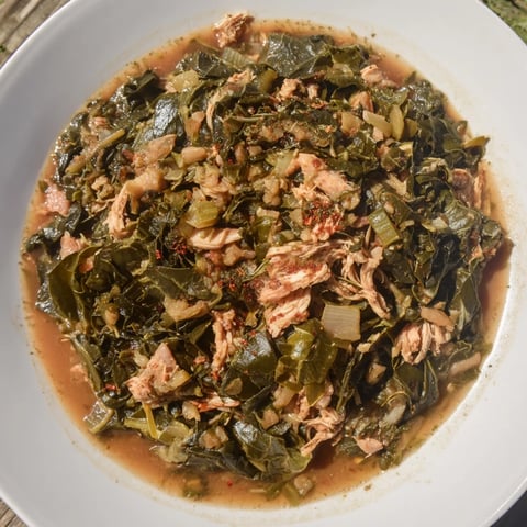 Steaming Southern style collard greens with tender bits of smoked turkey; a hearty, flavorful side.