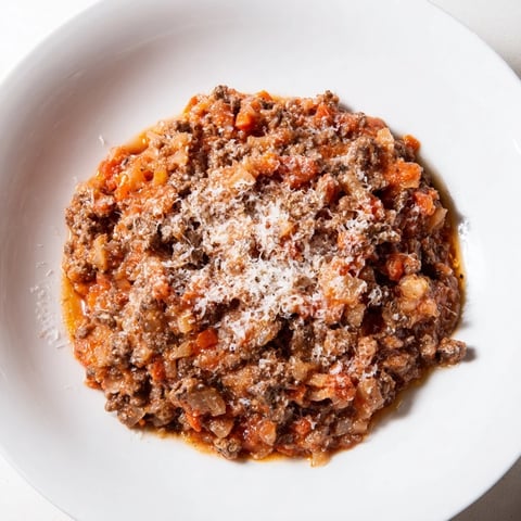 Close-up photo of steaming Classic Tuscan Ragu, a hearty meat sauce ready for pasta.