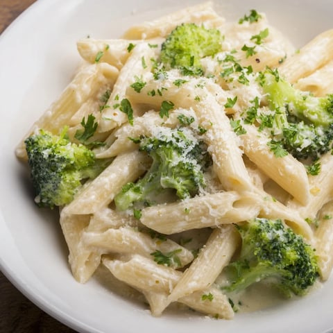 Cream Cheese Garlic Pasta glows with creamy sauce, broccoli, and inviting fresh parsley garnish.