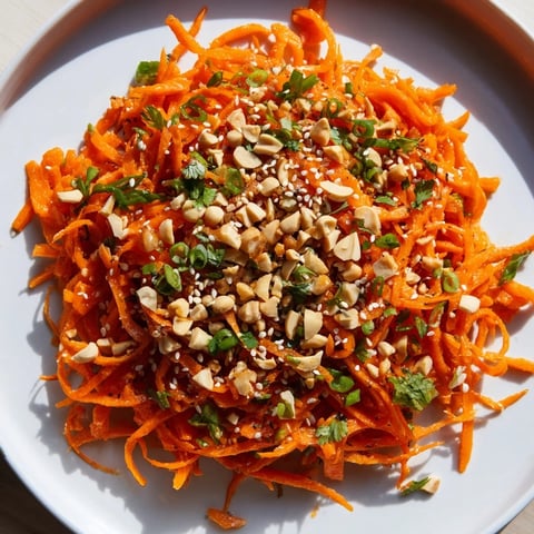 Bright photo shows the vibrant Spicy Carrot Salad, a flavorful Asian-inspired side dish with crunchy carrots.