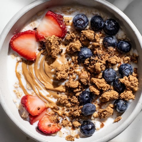 Hearty overnight oats gourmet makeover with fresh berries and nut butter swirls ready to enjoy.