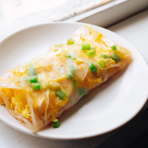 Golden-brown Rice Paper Egg & Cheese Fold, with melted cheese oozing from a crispy shell for a quick breakfast.