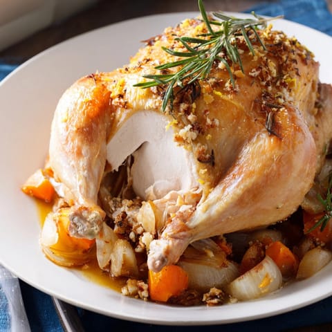 Close-up of crispy skin on Rosemary Garlic Roasted Chicken, ready for a family meal.