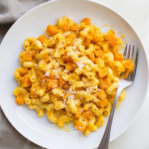 Creamy swirls of butternut squash enrich this one-pot mac and cheese, a comforting hidden veggie delight.