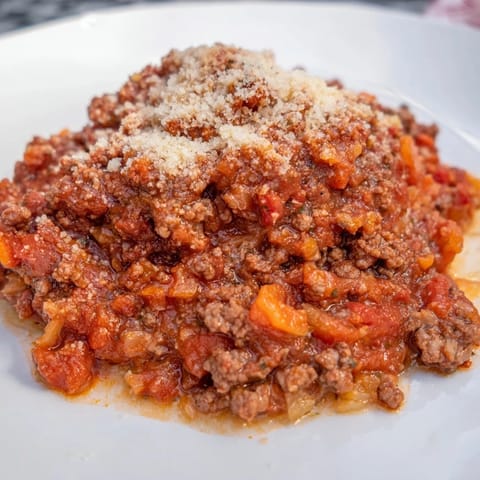 Savory Classic Tuscan Ragu simmering, the rich scent of Italian herbs filling the air.