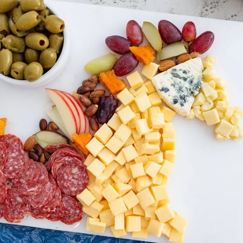 This horse-shaped grazing board beautifully displays assorted cheeses, charcuterie, and crackers, ideal for any gathering.