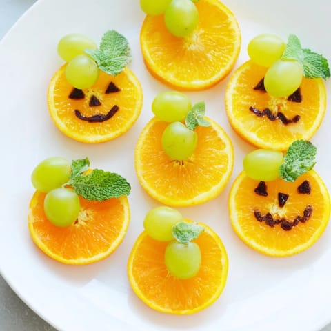 Vibrant photo of festive pumpkin patch orange slices with mint stems, a delicious and easy treat.