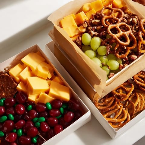 Festive Stacked Christmas Gift Snack Tower, full of layered treats with bright ribbon and bows.