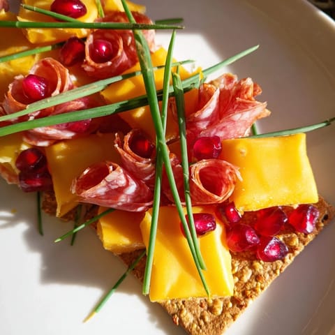 This Layered Urban Skyline appetizer presents a colorful mix of cheeses and meats, ready to enjoy.