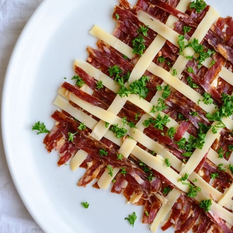 Woven The Tartan Plaid, a creative appetizer featuring jerky and cheese arranged for visual appeal.