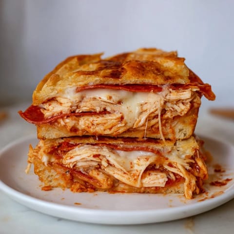 Crispy edges and a gooey cheese center: the ultimate Leftover Pizza Grilled Cheese ready to be enjoyed.