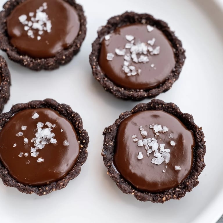 Mini tartlets filled with silky salted caramel and rich chocolate, perfect for dessert lovers.