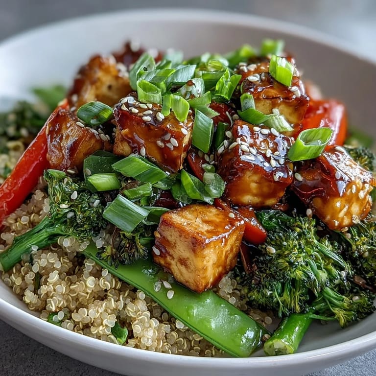 A close-up view of the wholesome Quinoa Vegetable Teriyaki Bowl, showcasing stir-fried broccoli and peppers with a savory glaze.