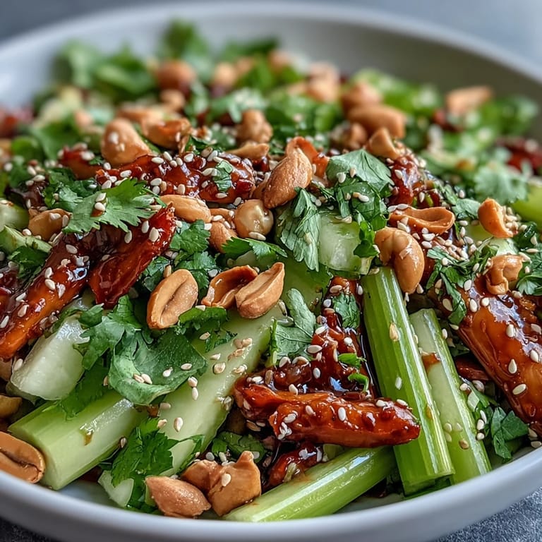Fresh and crunchy celery salad tossed with peanuts and zesty soy ginger dressing, perfect for a light lunch or refreshing side dish.