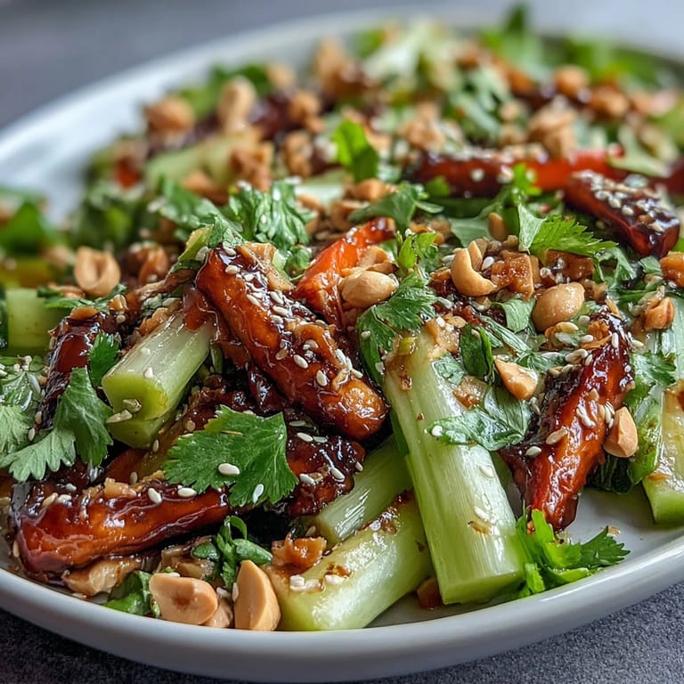 Vibrant Crunchy Celery Peanut Salad with bold soy ginger dressing, topped with roasted peanuts and sesame seeds for an irresistible Asian-inspired flavor.