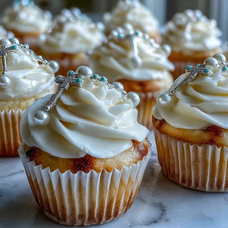 Delicate vanilla cupcakes topped with creamy buttercream and fondant rosary toppers, ideal for First Communion celebrations.