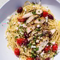 Grilled chicken, cherry tomatoes, and briny olives tossed with spaghetti in a vibrant Greek Chicken Spaghetti dish.