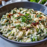 Creamy pea and mint risotto with Parmesan, bright green peas, and fresh herbs, perfect for a spring dinner party.  